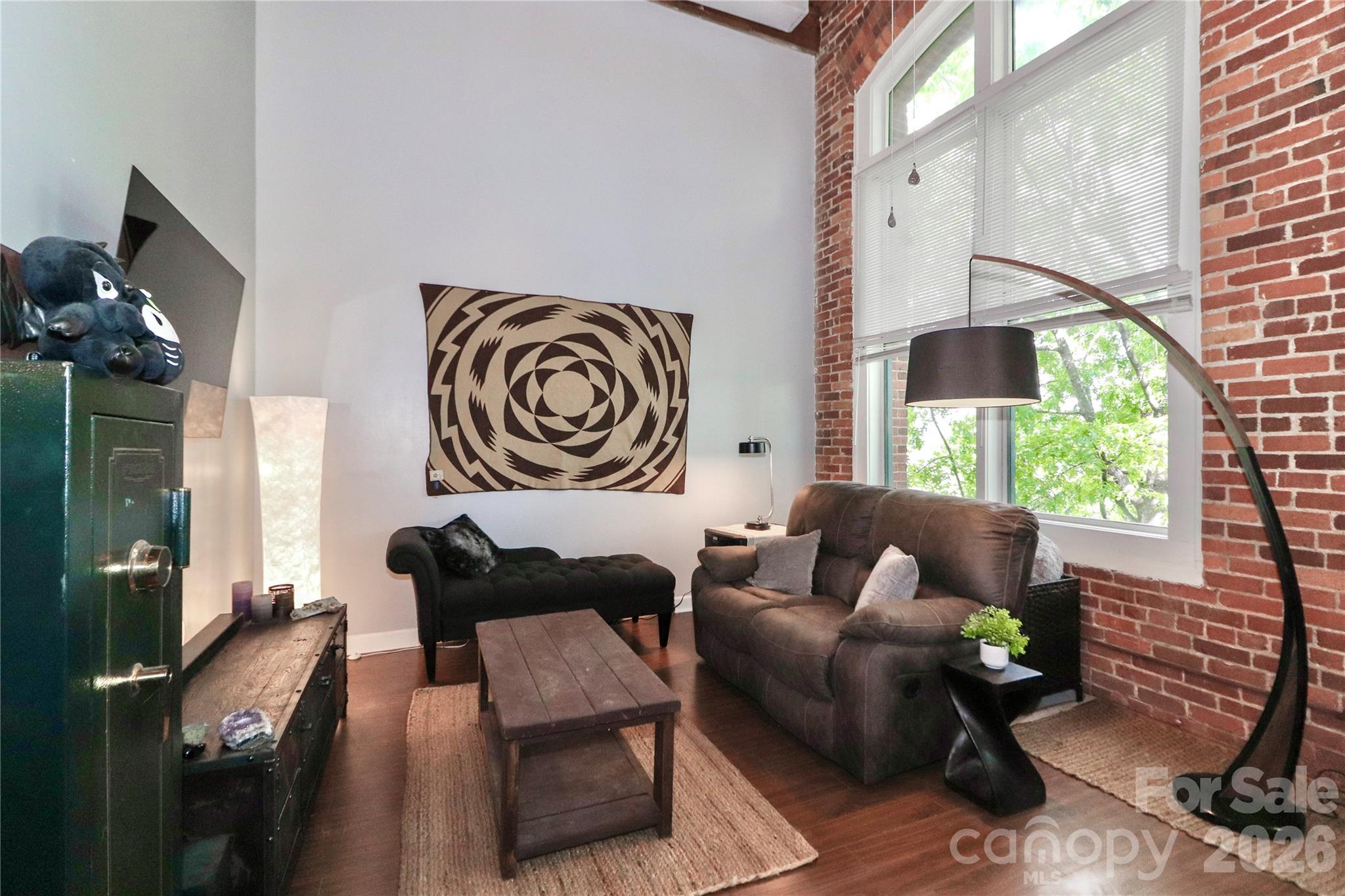 201 South Hoskins Road, Unit 315 Charlotte, NC 28208 - Photo 10 of 45 a living room with furniture and a floor to ceiling window