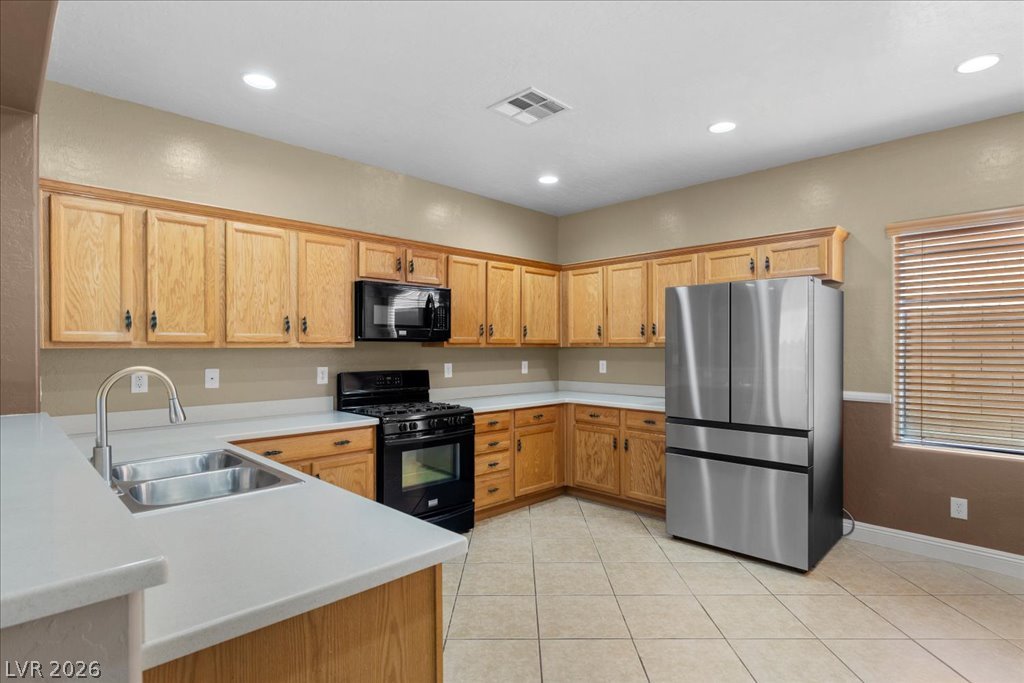 2627 Dirleton Place Henderson, NV 89044 - Photo 3 of 42 The refrigerator is approximately one year old, adding modern convenience to this functional kitchen