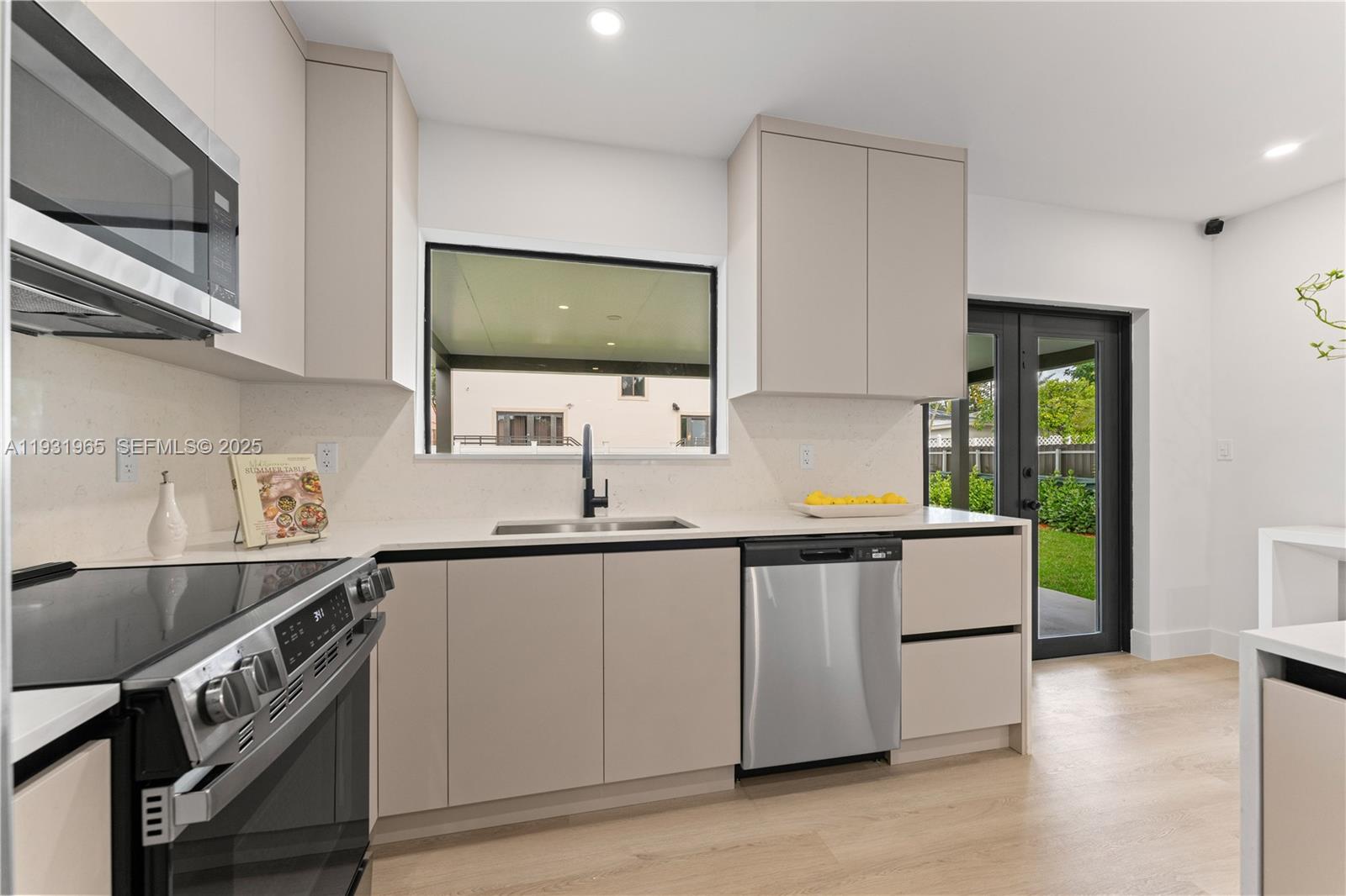 4555 Southwest 2nd Street Miami, FL 33134 - Photo 12 of 37 a kitchen with a sink and wooden cabinets