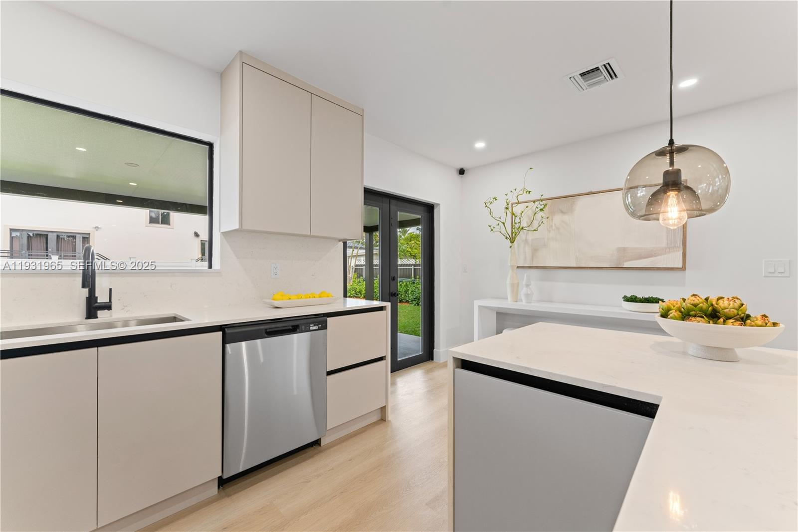 4555 Southwest 2nd Street Miami, FL 33134 - Photo 13 of 37 a kitchen with a sink and a refrigerator