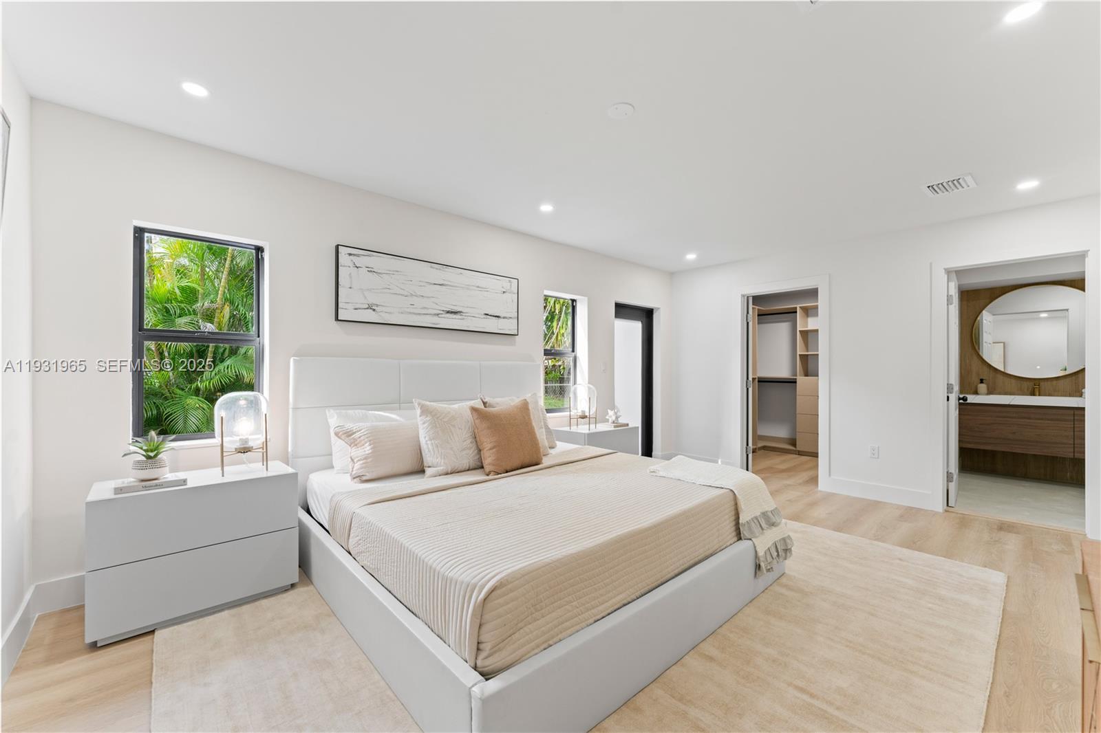 4555 Southwest 2nd Street Miami, FL 33134 - Photo 17 of 37 a bedroom with a large bed and a large window