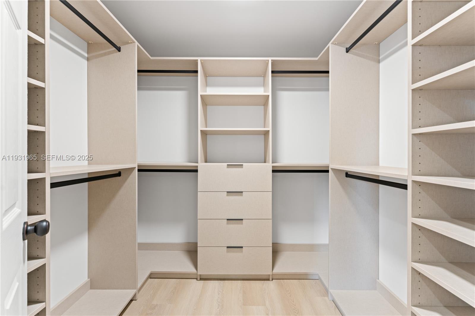 4555 Southwest 2nd Street Miami, FL 33134 - Photo 19 of 37 a view of walk in closet with empty racks