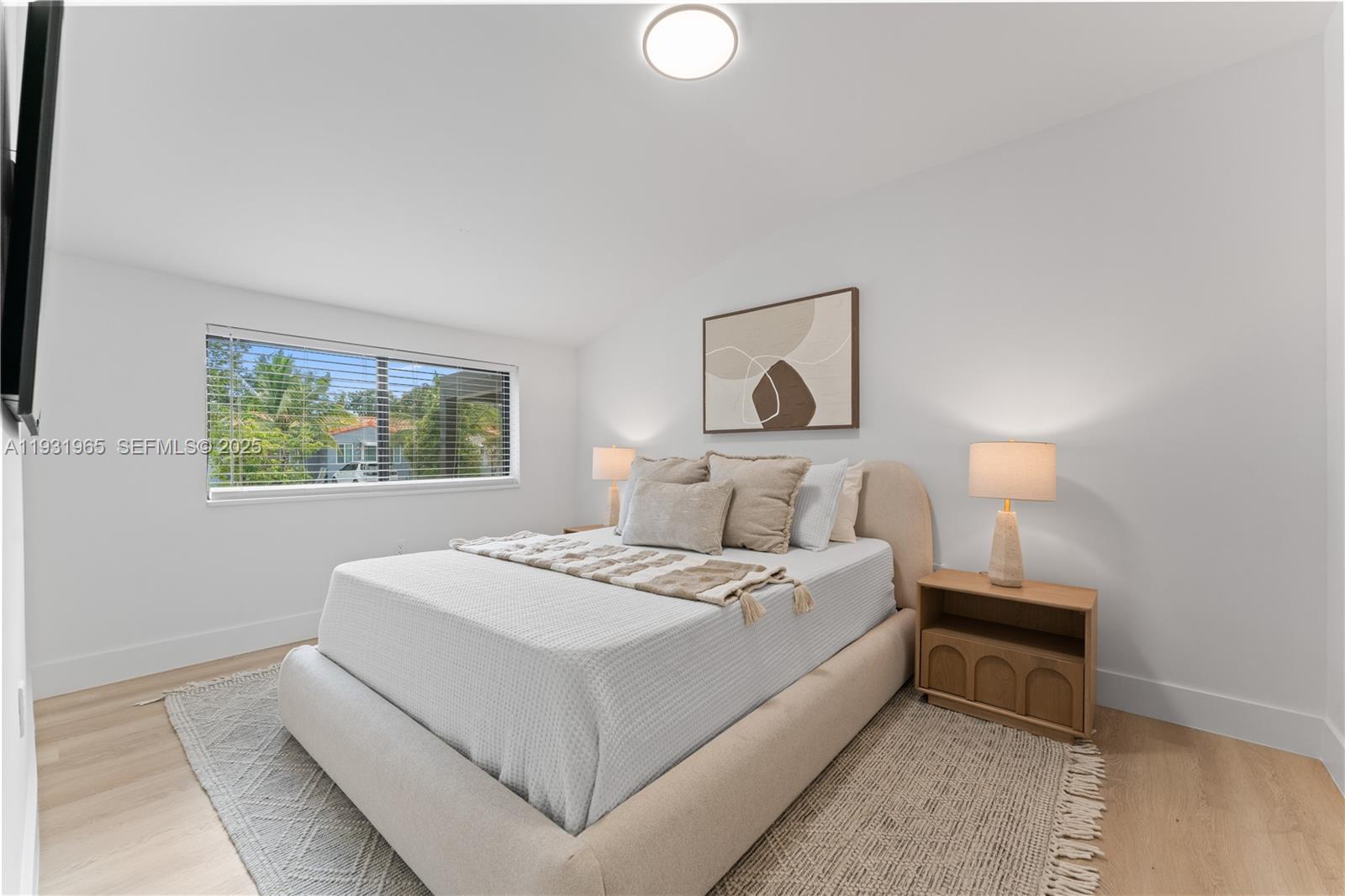 4555 Southwest 2nd Street Miami, FL 33134 - Photo 21 of 37 a bedroom with a bed and a window