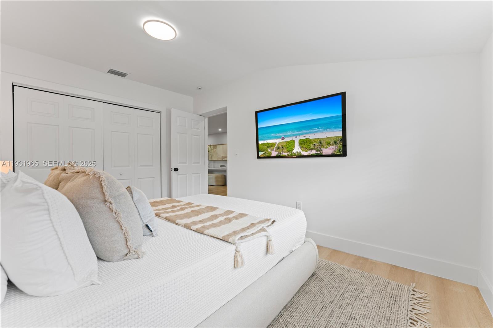 4555 Southwest 2nd Street Miami, FL 33134 - Photo 22 of 37 a bedroom with a bed and a painting on the wall