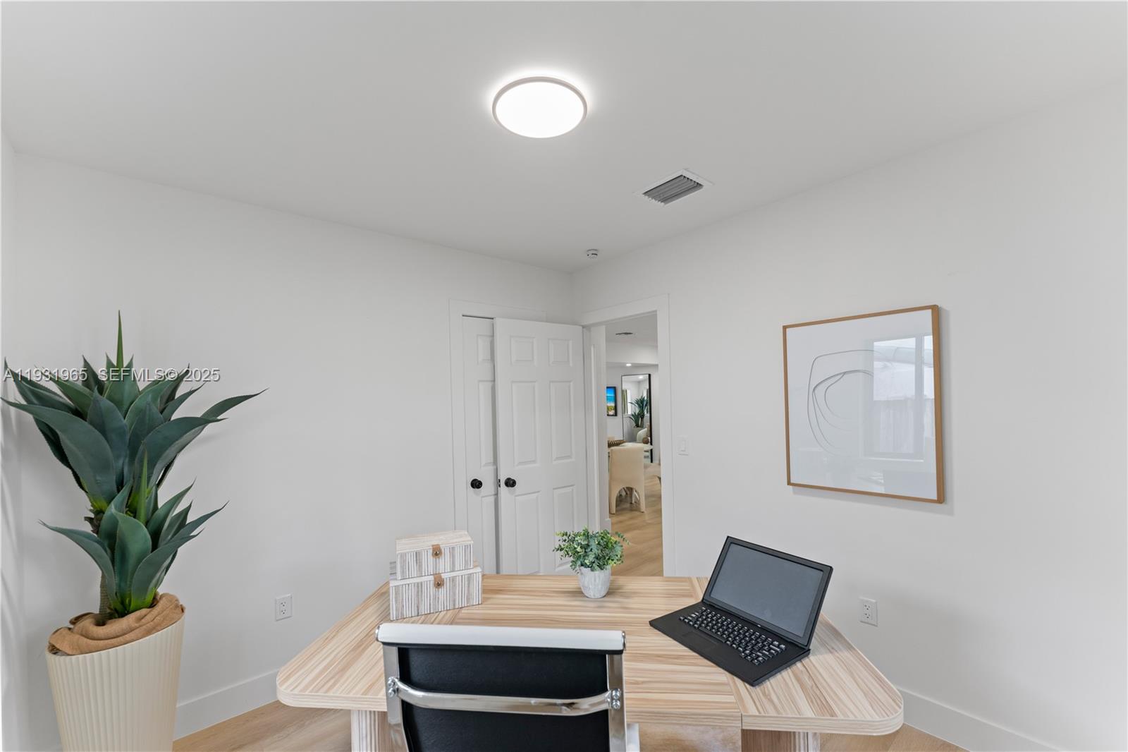 4555 Southwest 2nd Street Miami, FL 33134 - Photo 25 of 37 a view of a workspace with furniture and wooden floor