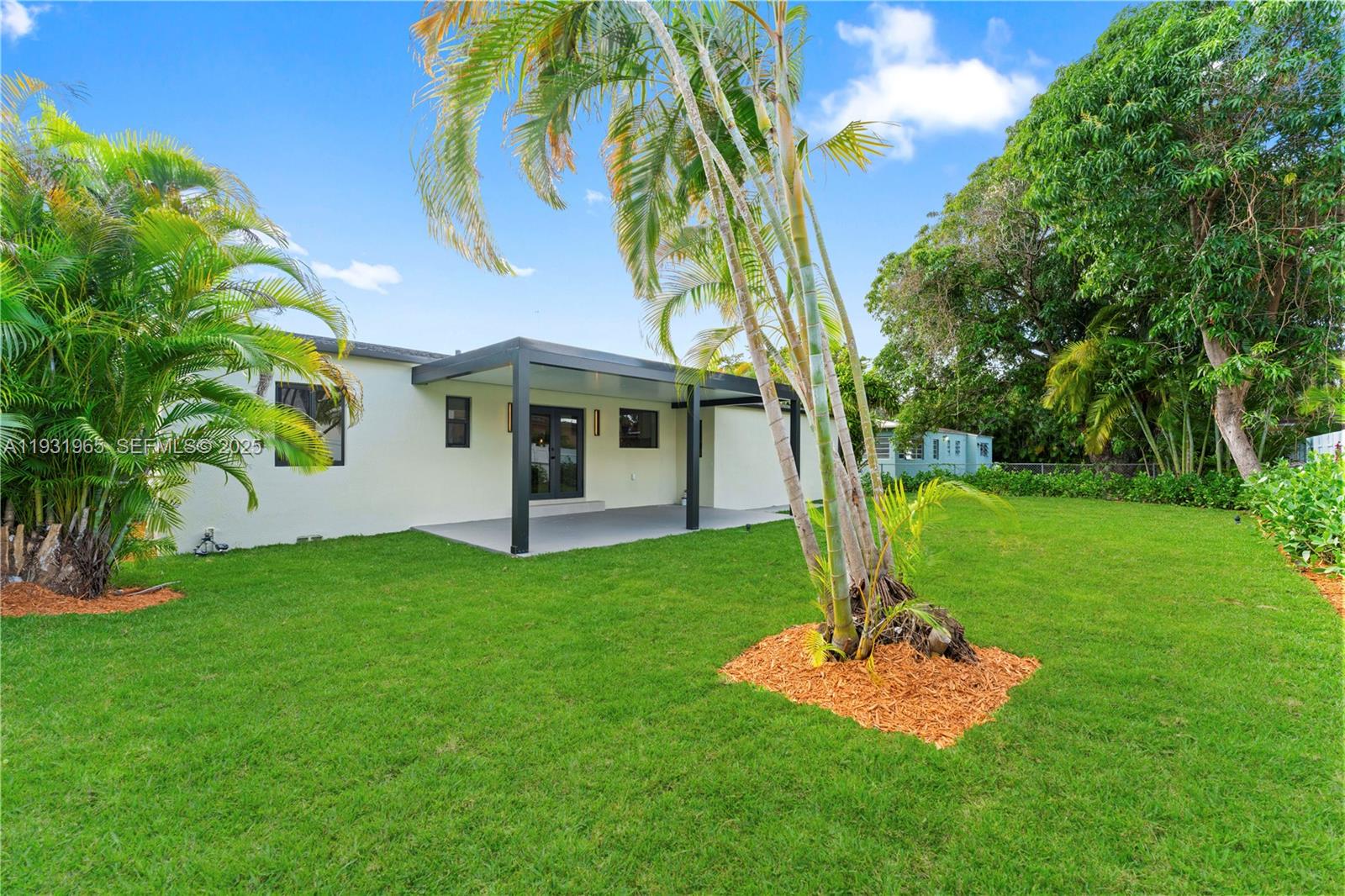4555 Southwest 2nd Street Miami, FL 33134 - Photo 29 of 37 a front view of a house with a yard and garage