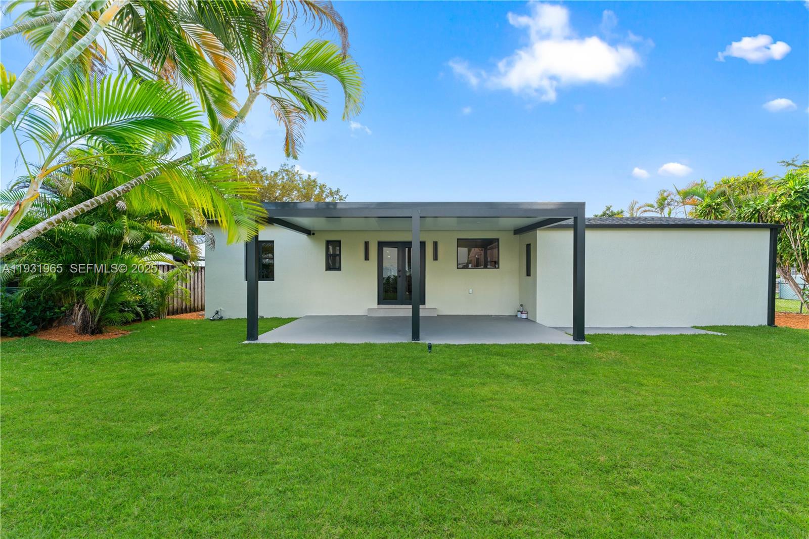 4555 Southwest 2nd Street Miami, FL 33134 - Photo 30 of 37 a backyard of a house with plants and large tree