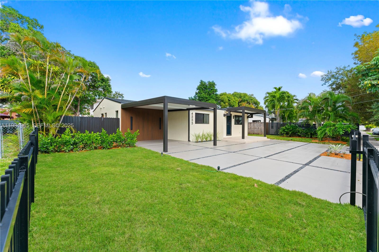 4555 Southwest 2nd Street Miami, FL 33134 - Photo 3 of 37 a front view of a house with a yard