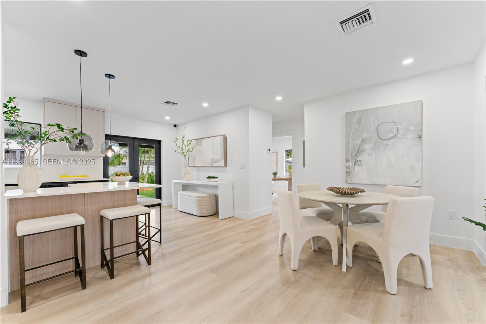 4555 Southwest 2nd Street Miami, FL 33134 - Photo 7 of 37 a kitchen with stainless steel appliances kitchen island granite countertop a table chairs and a refrigerator