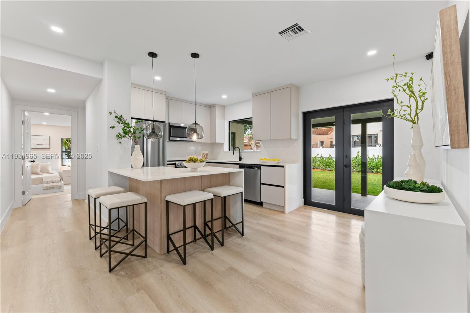 4555 Southwest 2nd Street Miami, FL 33134 - Photo 10 of 37 a large kitchen with a table and chairs in it