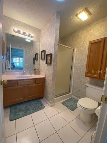 a bathroom with a sink a toilet a mirror and vanity