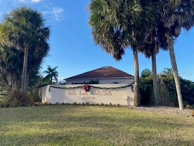 a view of a house with a yard and a garage