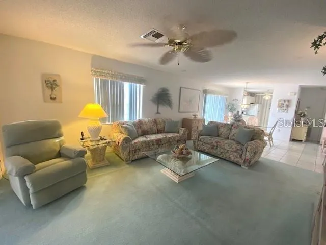 a living room with furniture and a lamp