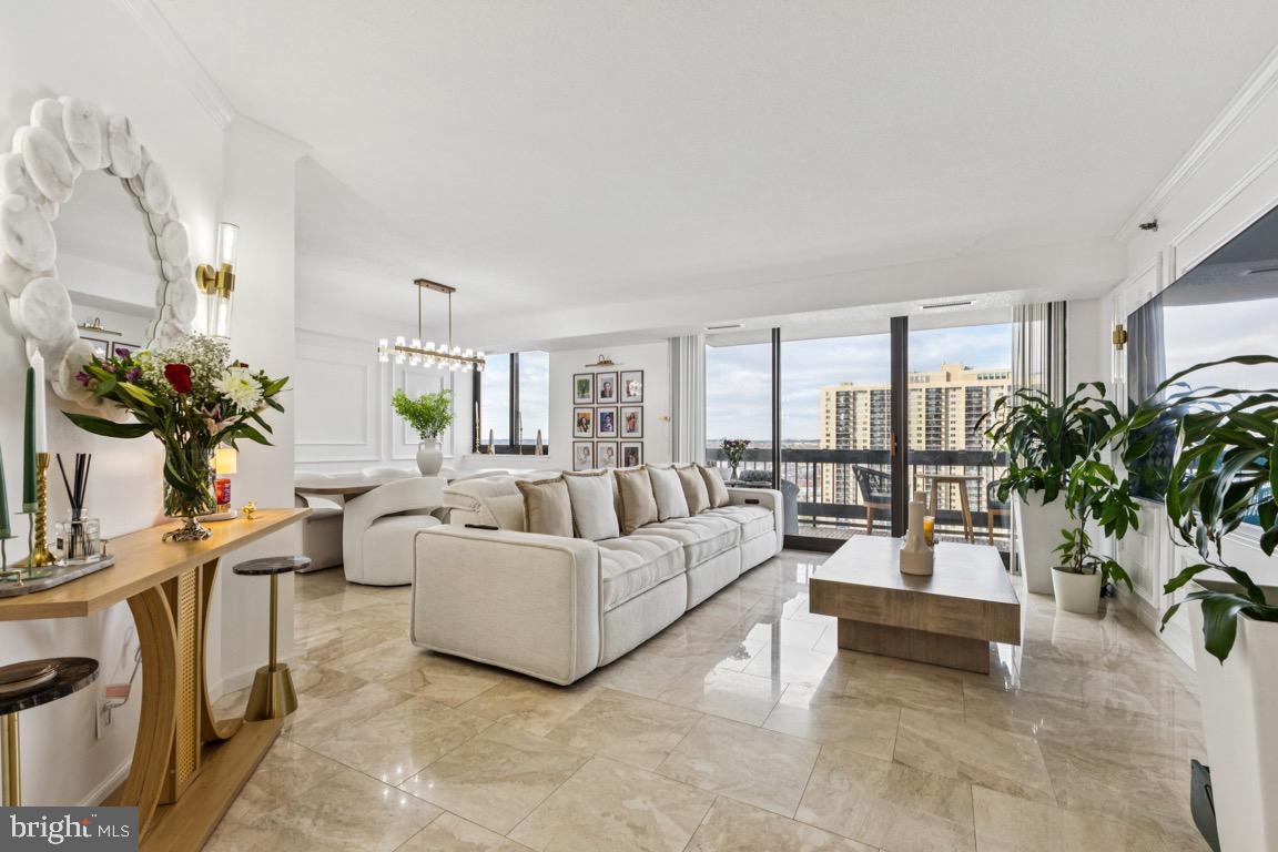a living room with furniture potted plant and a large window