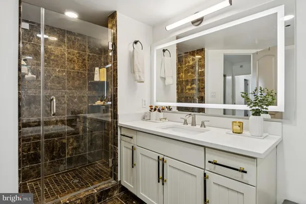 a bathroom with a shower sink and mirror