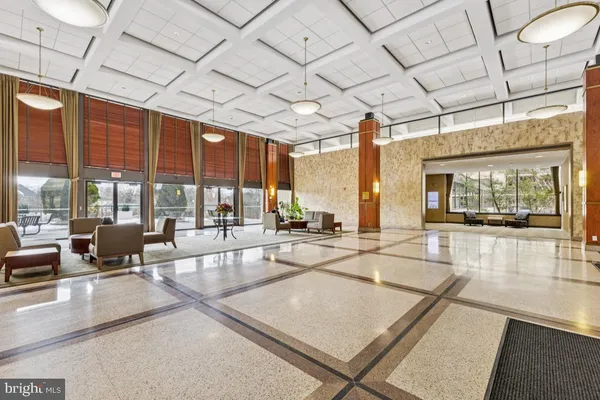 a lobby with furniture and large windows