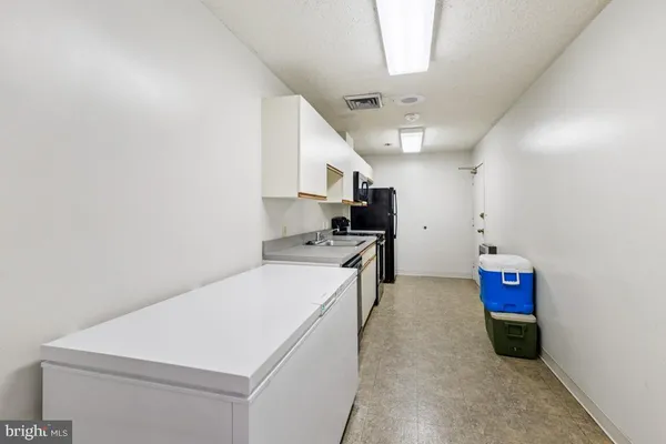 a kitchen with a refrigerator a stove top oven a sink and dishwasher