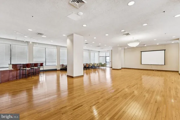 a view of empty room with kitchen and a sink