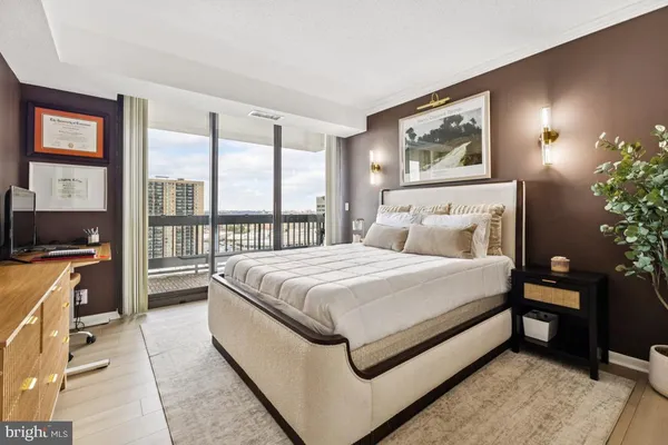 a spacious bedroom with a bed and glass windows
