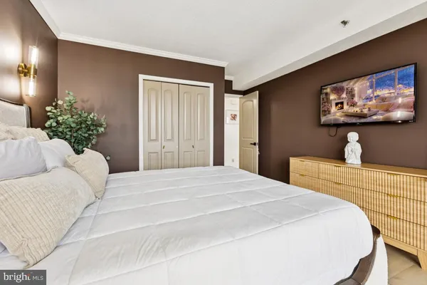 a bedroom with a bed and a flat screen tv