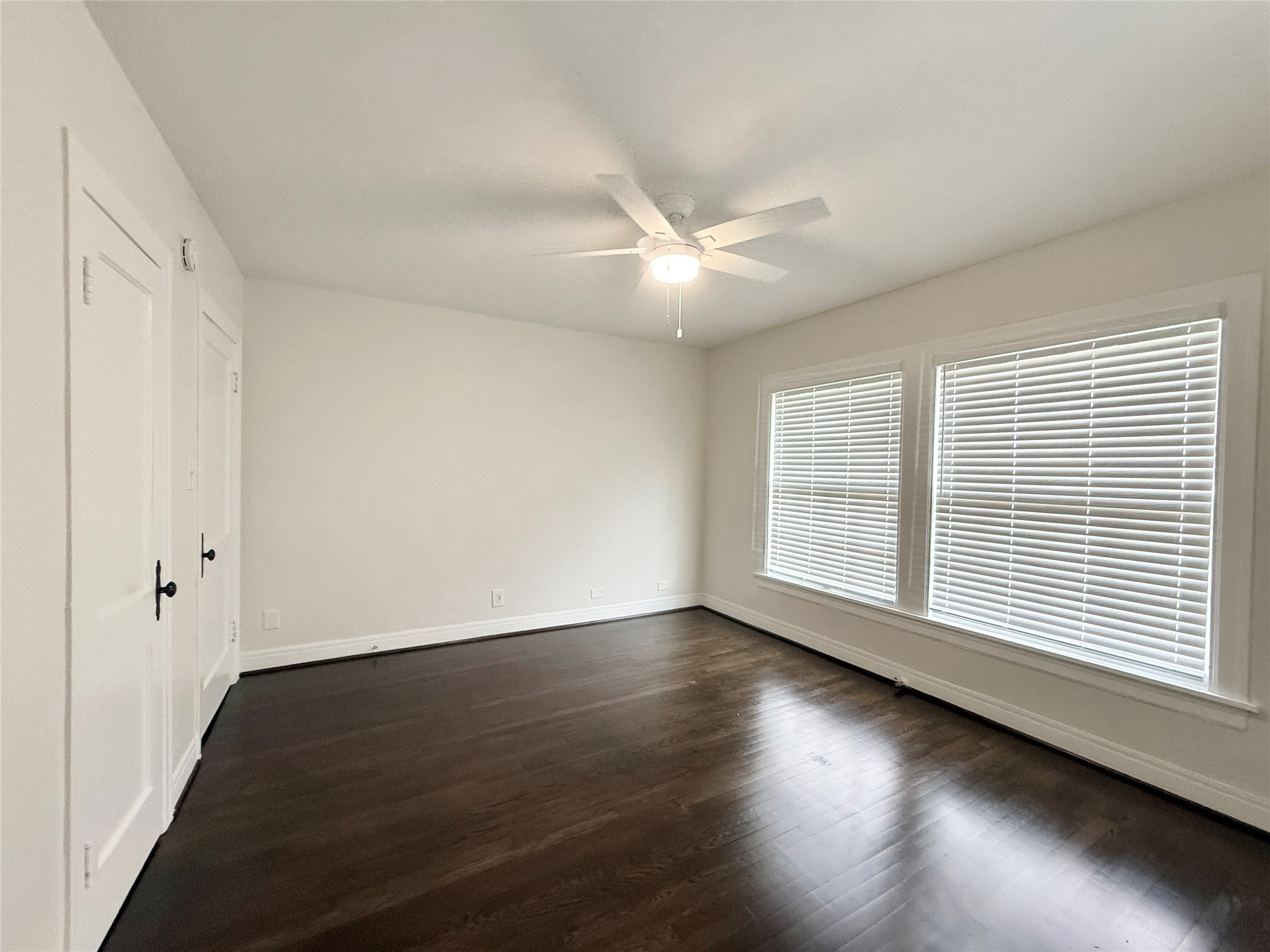 5402 Jackson Street, Unit 1 Houston, TX 77004 - Photo 12 of 18 a view of an empty room with wooden floor and a window