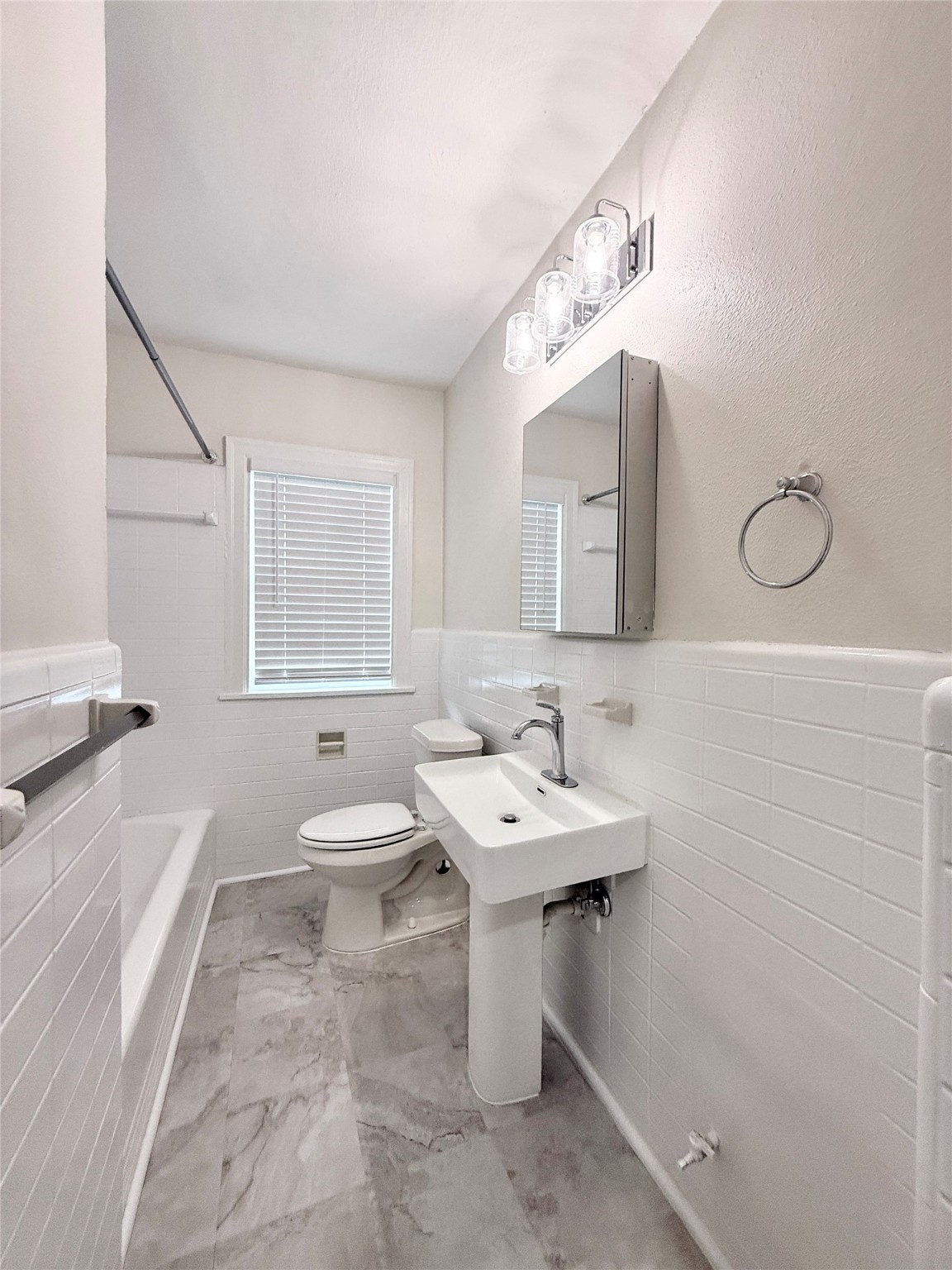 5402 Jackson Street, Unit 1 Houston, TX 77004 - Photo 13 of 18 a bathroom with a sink a toilet and mirror