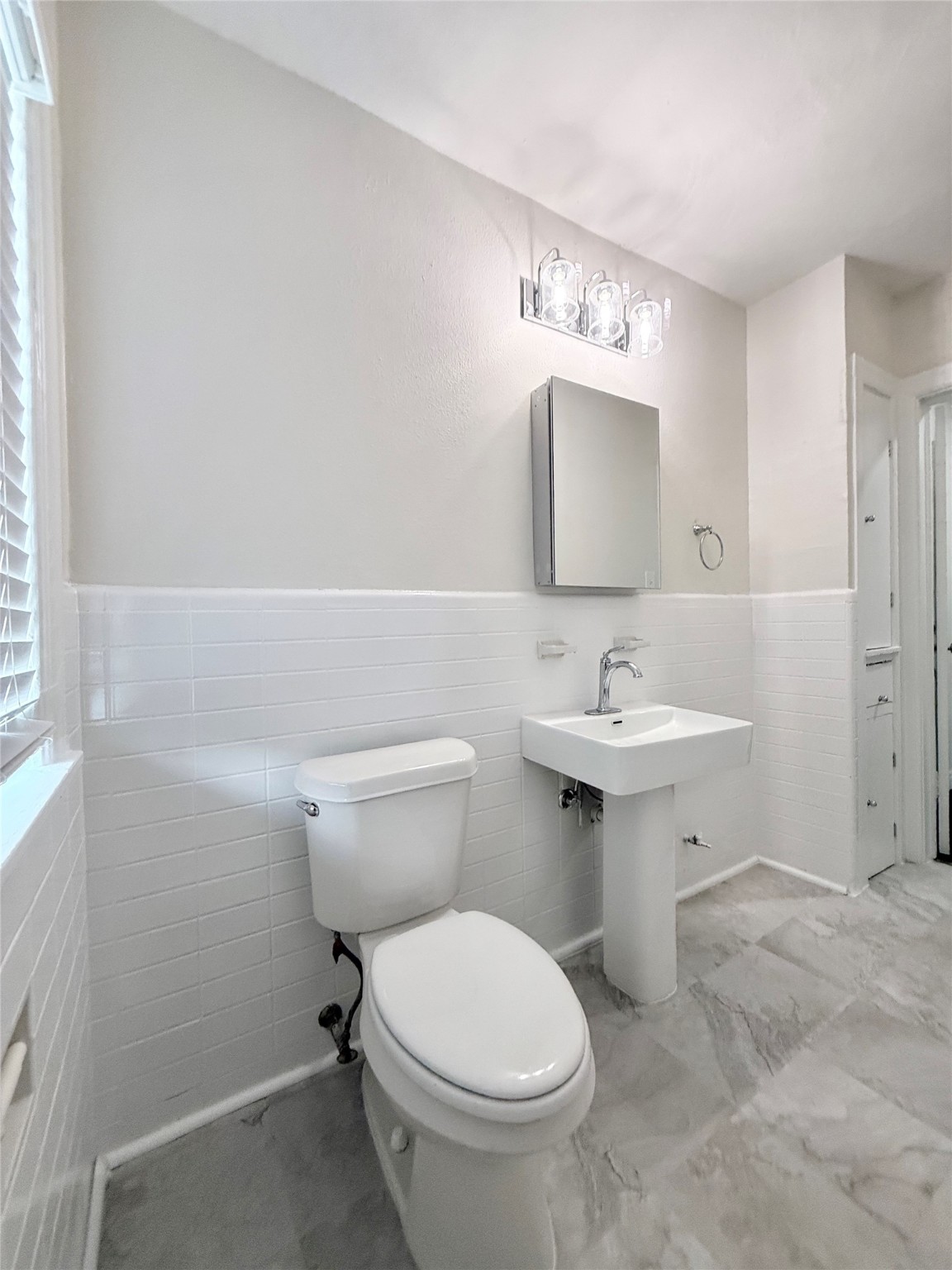 5402 Jackson Street, Unit 1 Houston, TX 77004 - Photo 14 of 18 a bathroom with a sink toilet and mirror