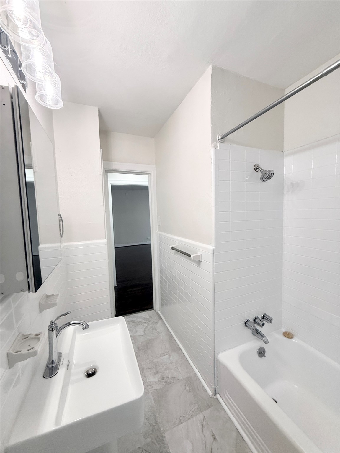 5402 Jackson Street, Unit 1 Houston, TX 77004 - Photo 15 of 18 a bathroom with a tub sink and mirror