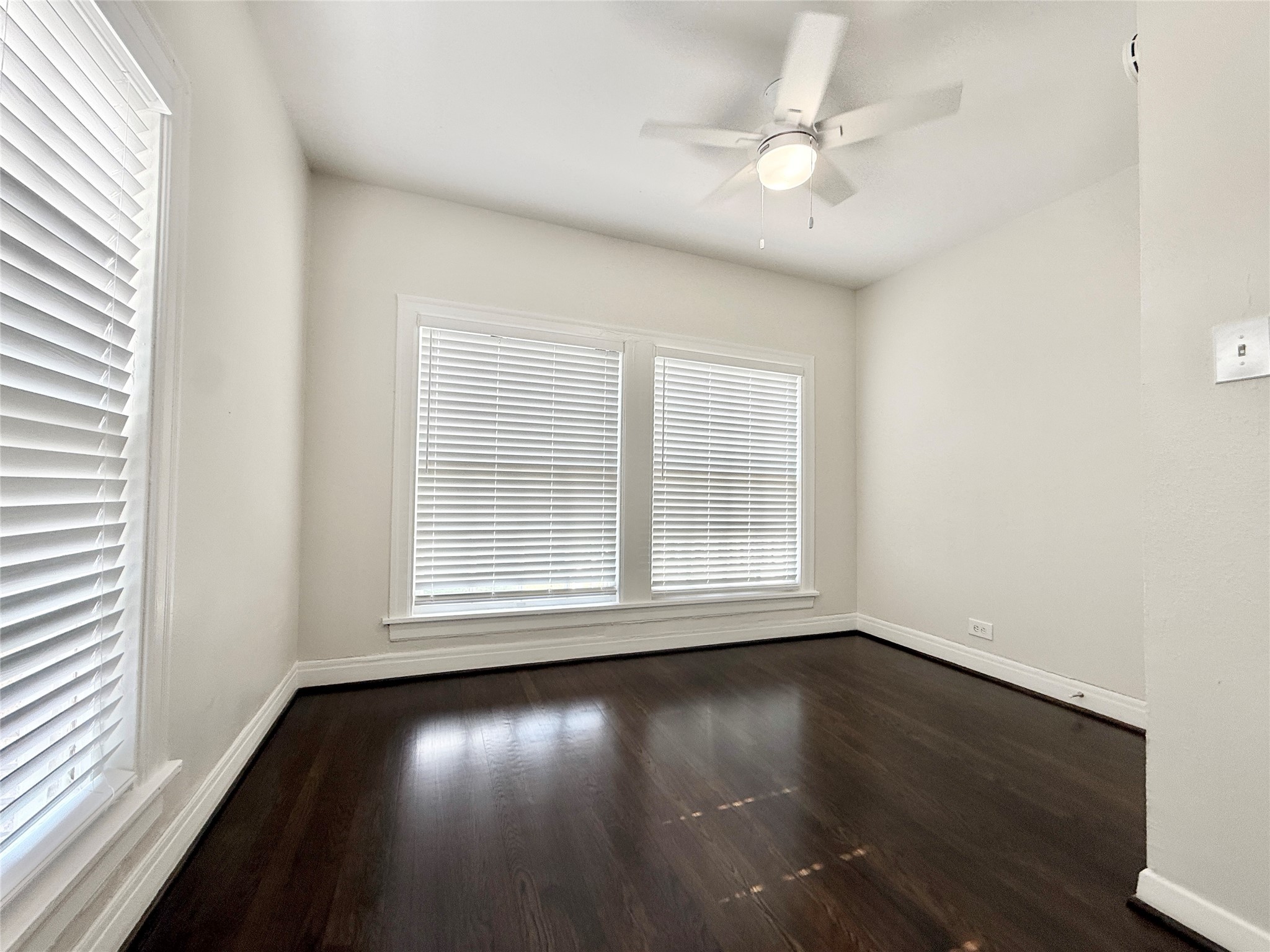 5402 Jackson Street, Unit 1 Houston, TX 77004 - Photo 16 of 18 an empty room with wooden floor and windows