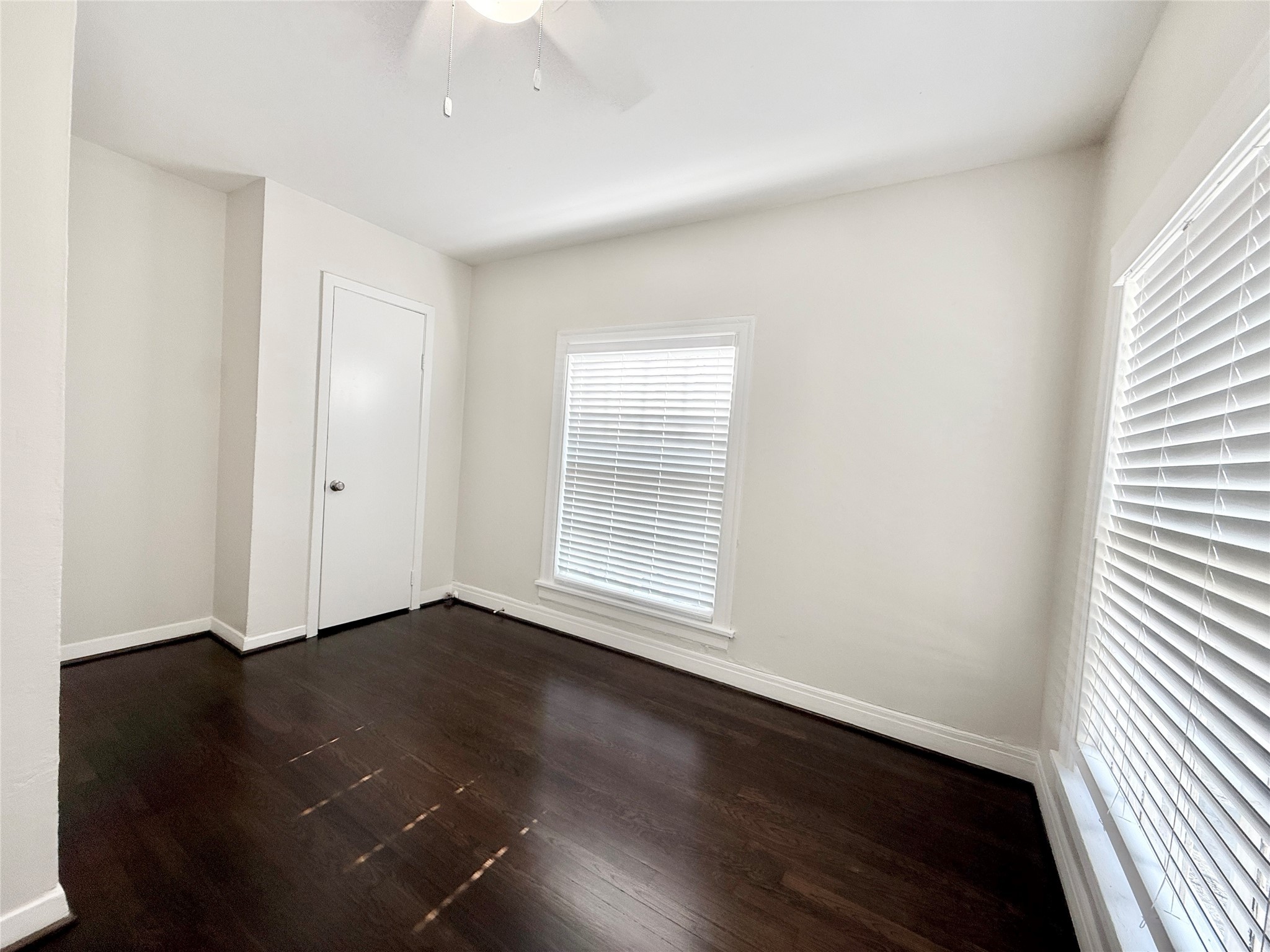 5402 Jackson Street, Unit 1 Houston, TX 77004 - Photo 18 of 18 an empty room with wooden floor and windows
