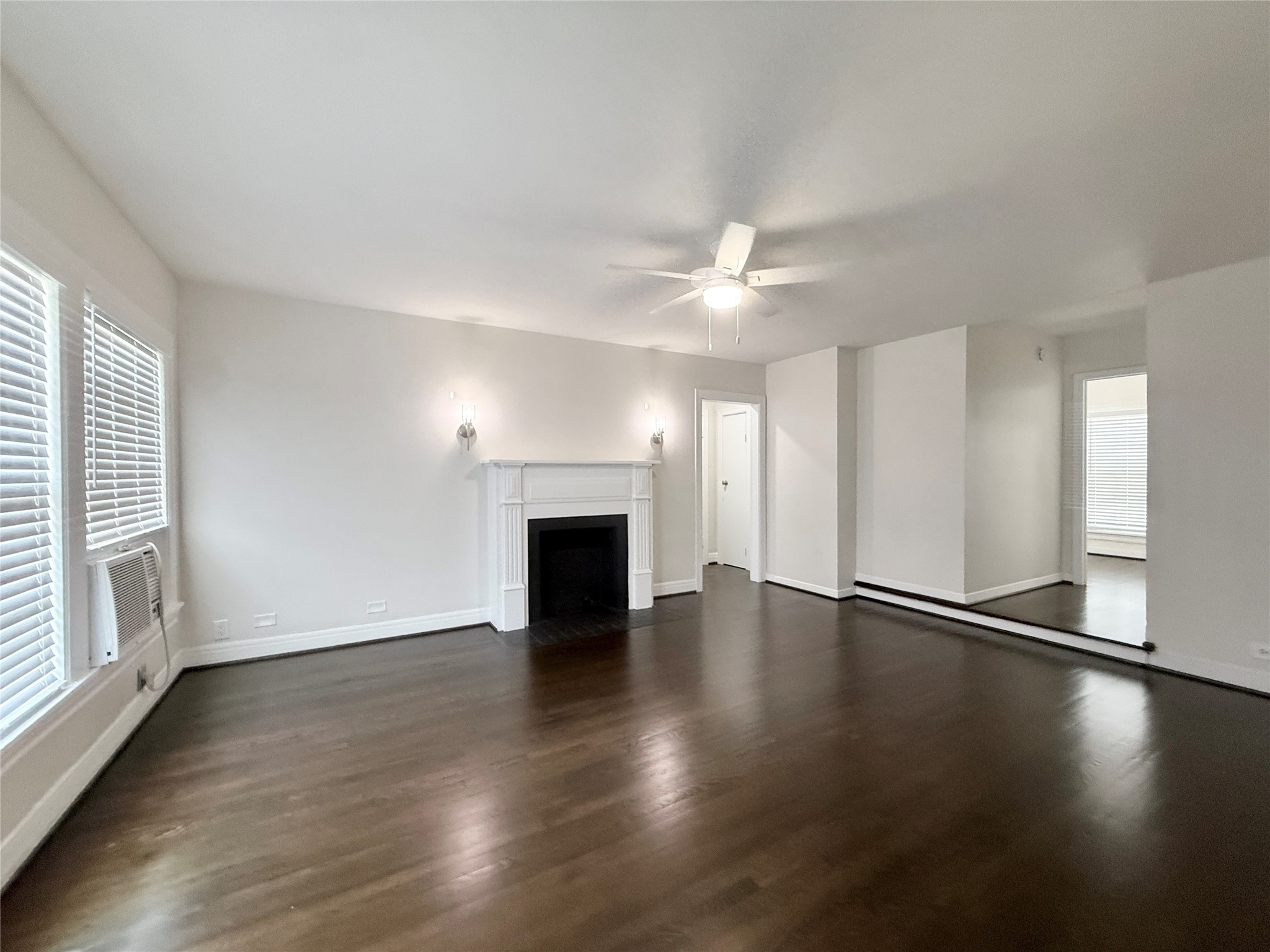 5402 Jackson Street, Unit 1 Houston, TX 77004 - Photo 2 of 18 an empty room with wooden floor fireplace and windows