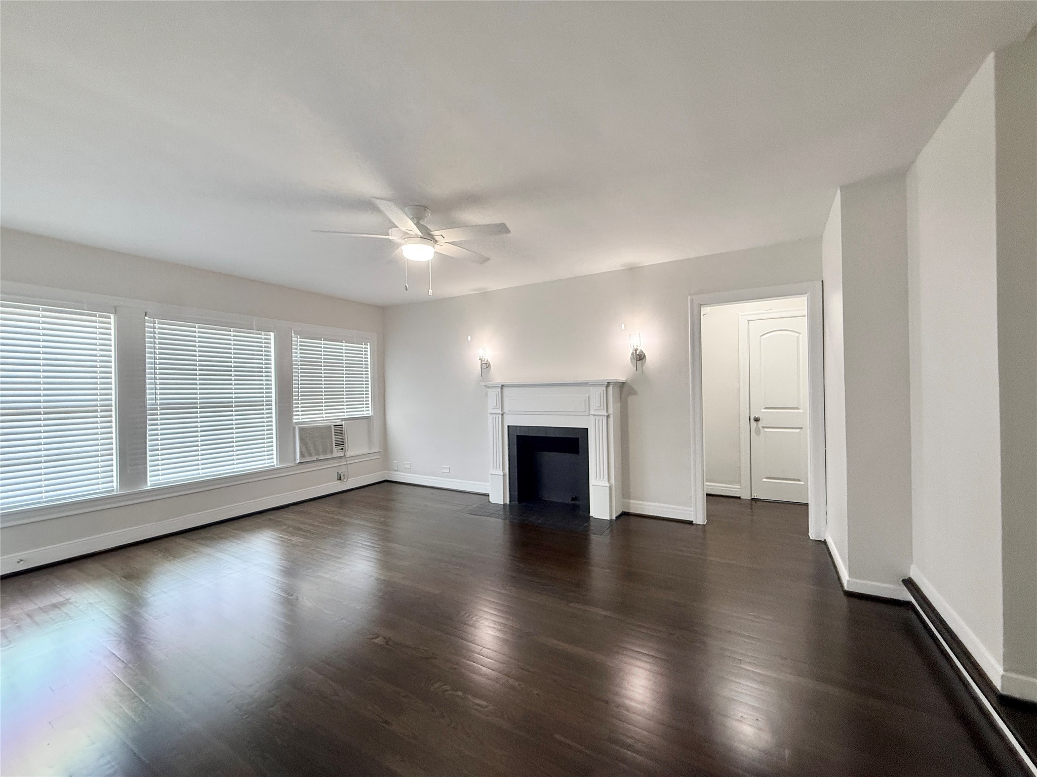 5402 Jackson Street, Unit 1 Houston, TX 77004 - Photo 4 of 18 an empty room with wooden floor fireplace and windows