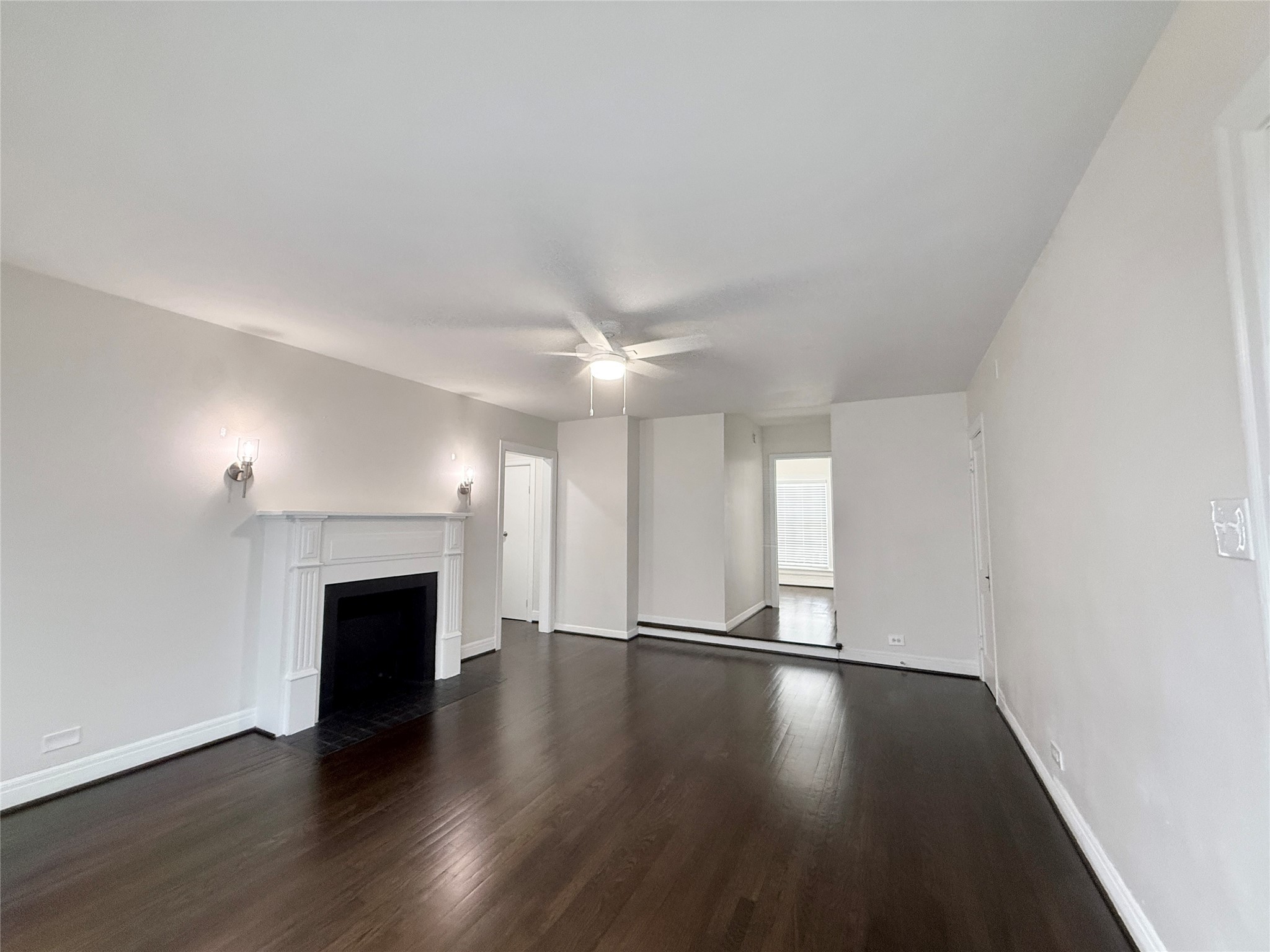 5402 Jackson Street, Unit 1 Houston, TX 77004 - Photo 5 of 18 an empty room with wooden floor fireplace and windows