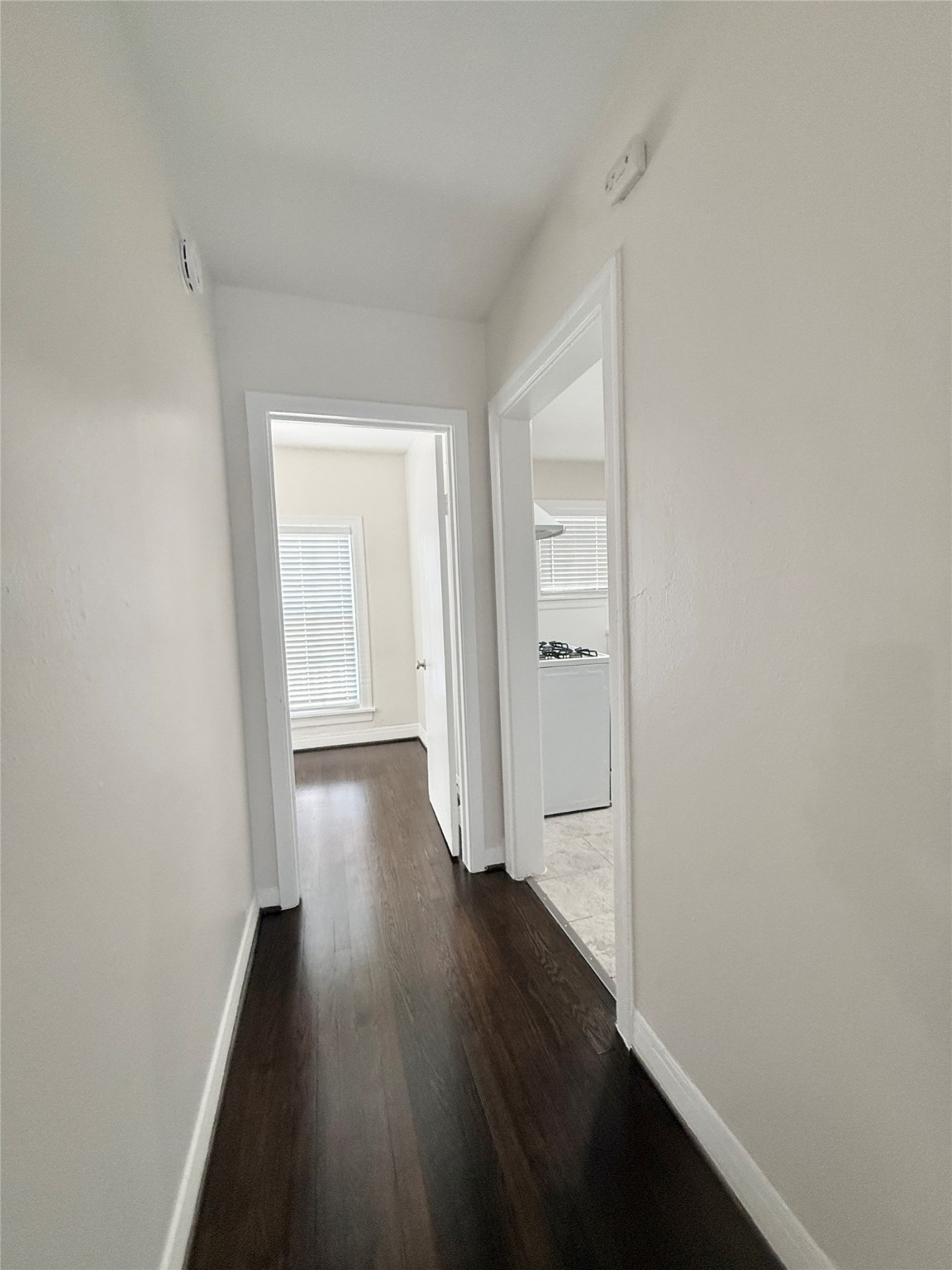 5402 Jackson Street, Unit 1 Houston, TX 77004 - Photo 6 of 18 wooden floor in a hall with an empty room