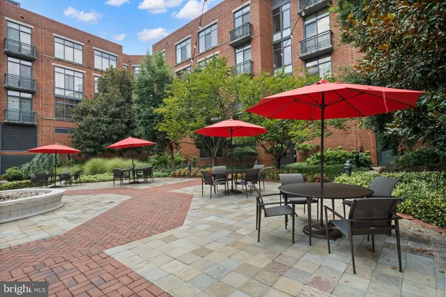 a view of a patio with a table and chairs under an umbrella