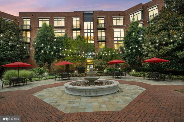 a swimming pool with outdoor seating and yard in front of it
