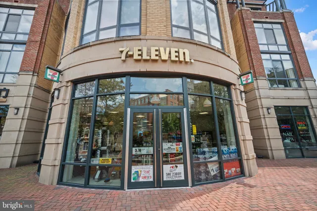 a view of a cafe with a table and chairs under an umbrella