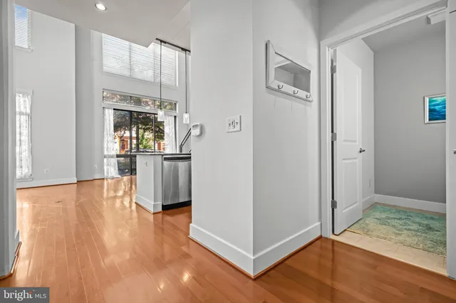 a view of a kitchen with furniture and wooden floor