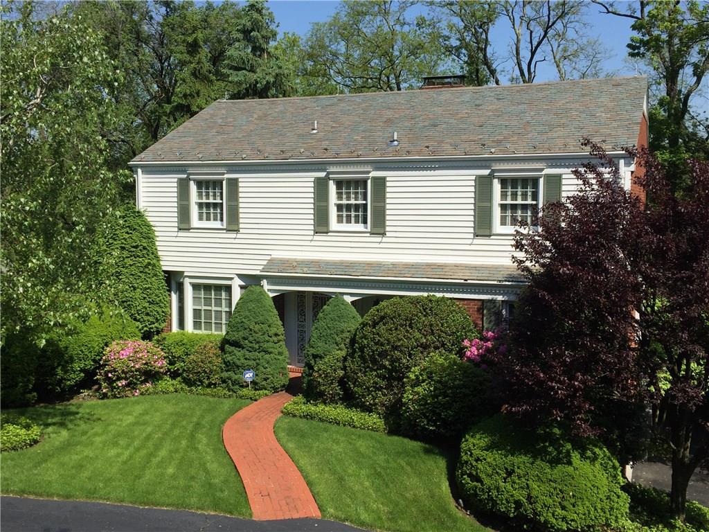 This photo was snapped from Old Hickory Road, and shows the home's private setting, surrounded by blooming spring foliage. The entry to the integral two-car garage is on the side of the home but is obscured in this view.
