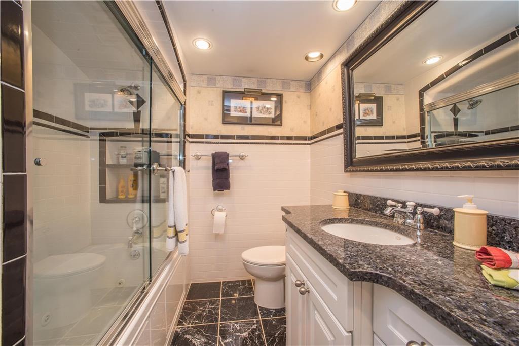 885 Old Hickory Road Mt. Lebanon, PA 15243 - Photo 19 of 25 Black and white subway tiling accents add extra panache to the already stylish full bath on the lower level. Granite countertop, recessed lights, tiled combination tub and shower, and radiant floor heating are also featured here.