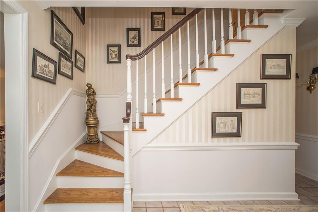 This beautiful balustrade with richly toned handrails on the oak staircase to the second floor greet visitors in the elegant foyer. A guest power room is also located in the foyer.