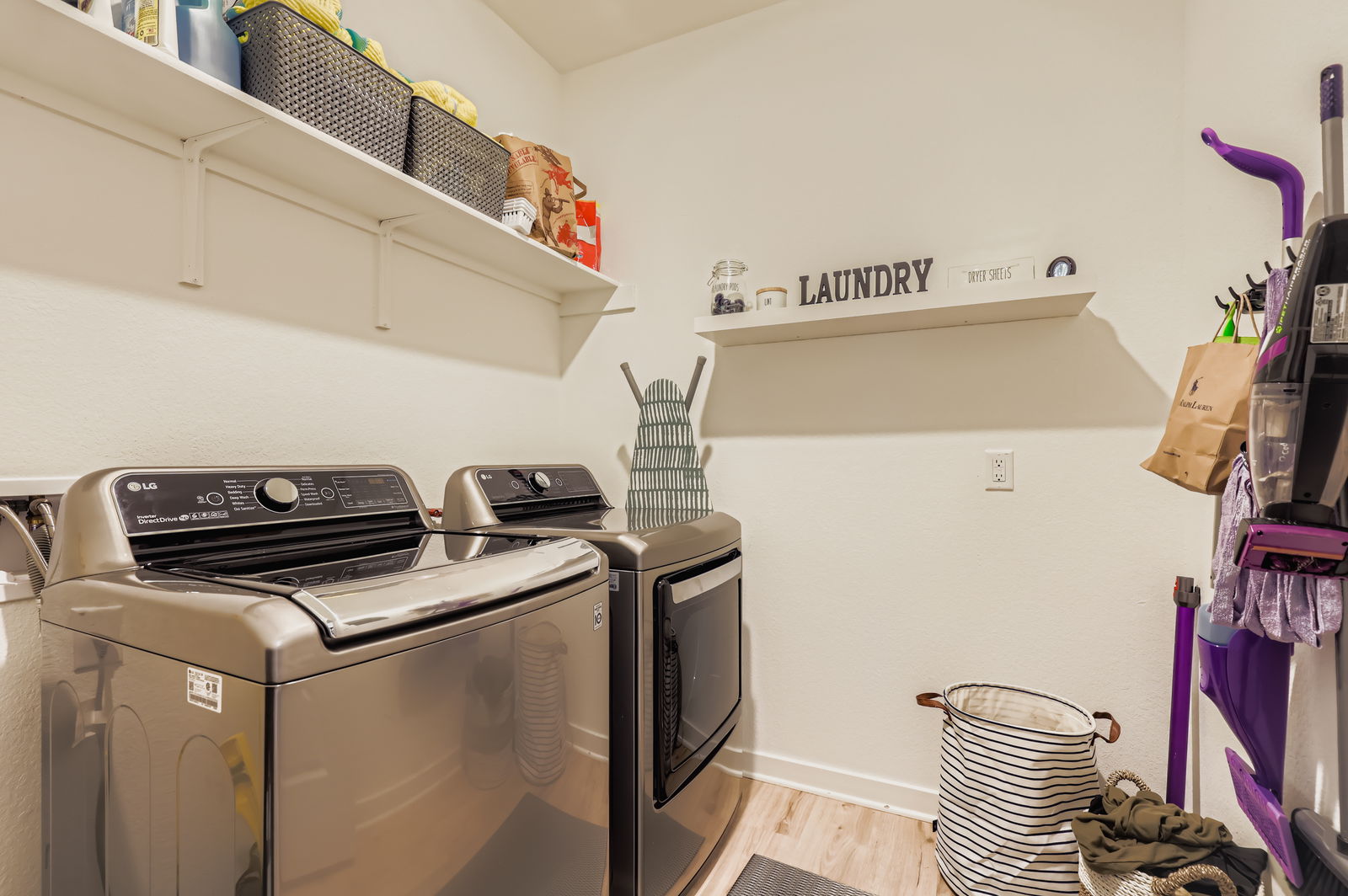 1909 Ruger Pass Leander, TX 78641 - Photo 23 of 31 Laundry room featuring washer and dryer and light wood-type flooring