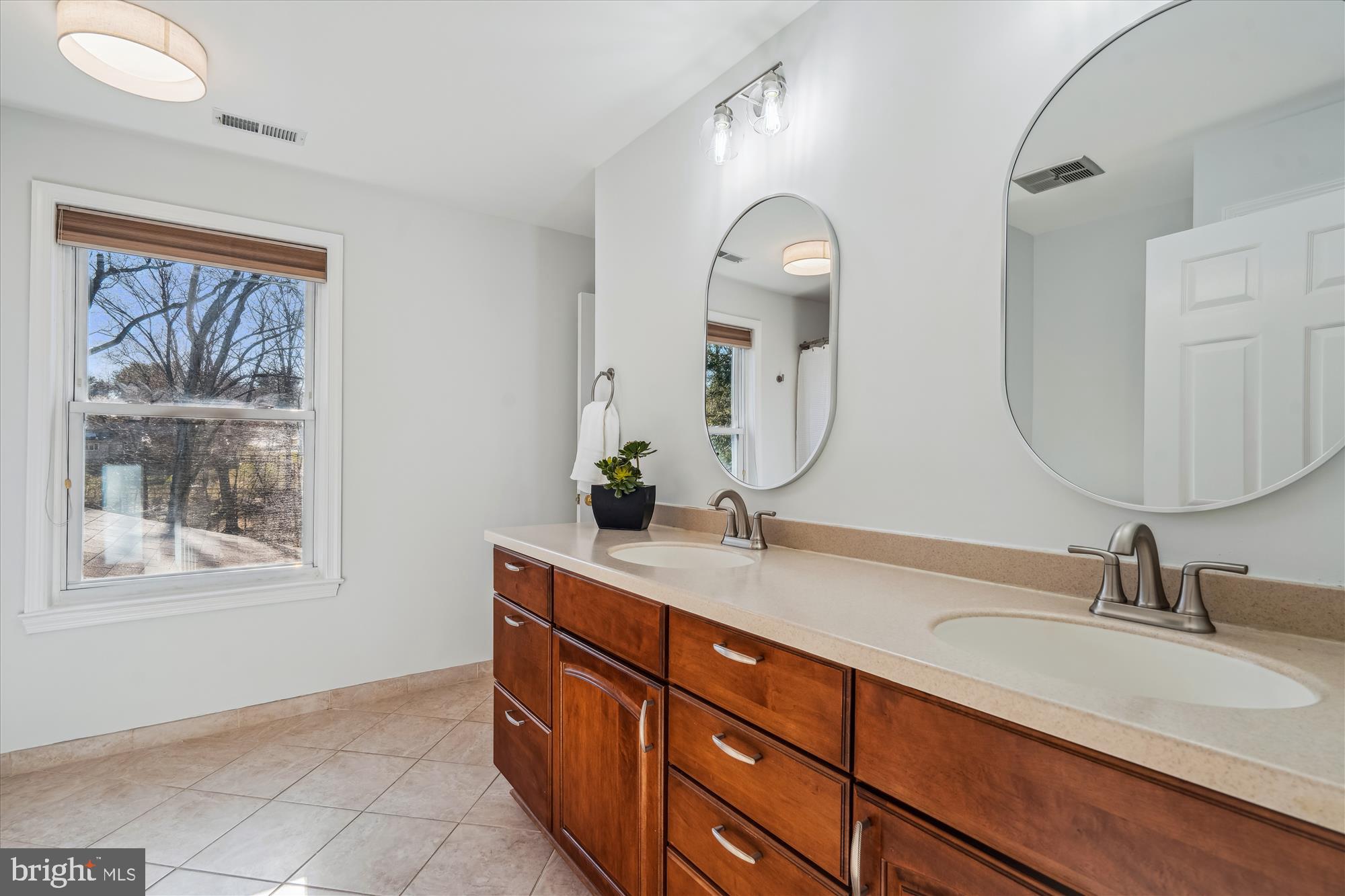 4048 Arjay Circle Ellicott City, MD 21042 - Photo 22 of 56 a bathroom with a granite countertop double vanity sinks and a mirror