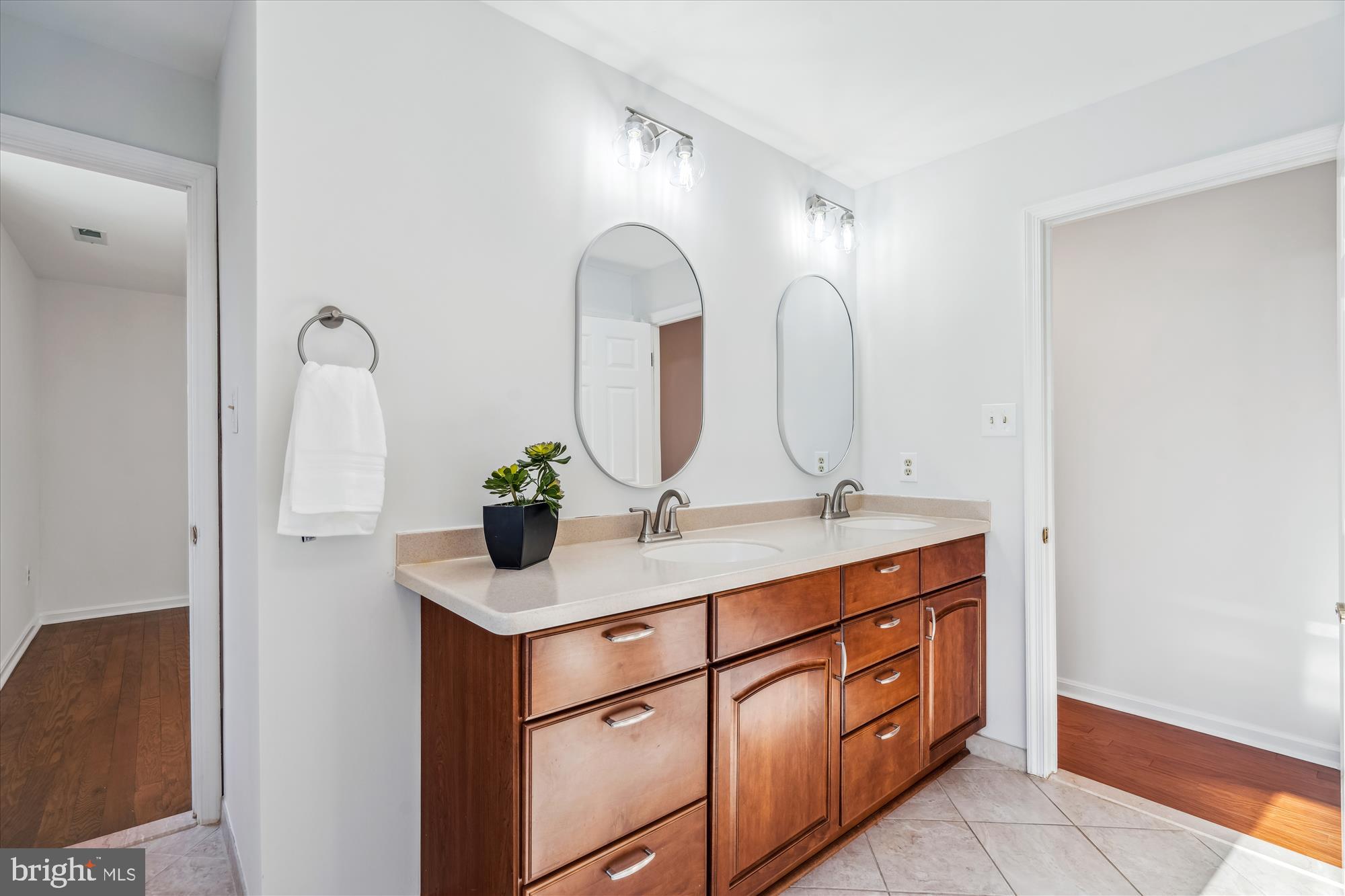 4048 Arjay Circle Ellicott City, MD 21042 - Photo 23 of 56 a bathroom with a double vanity sink and a mirror