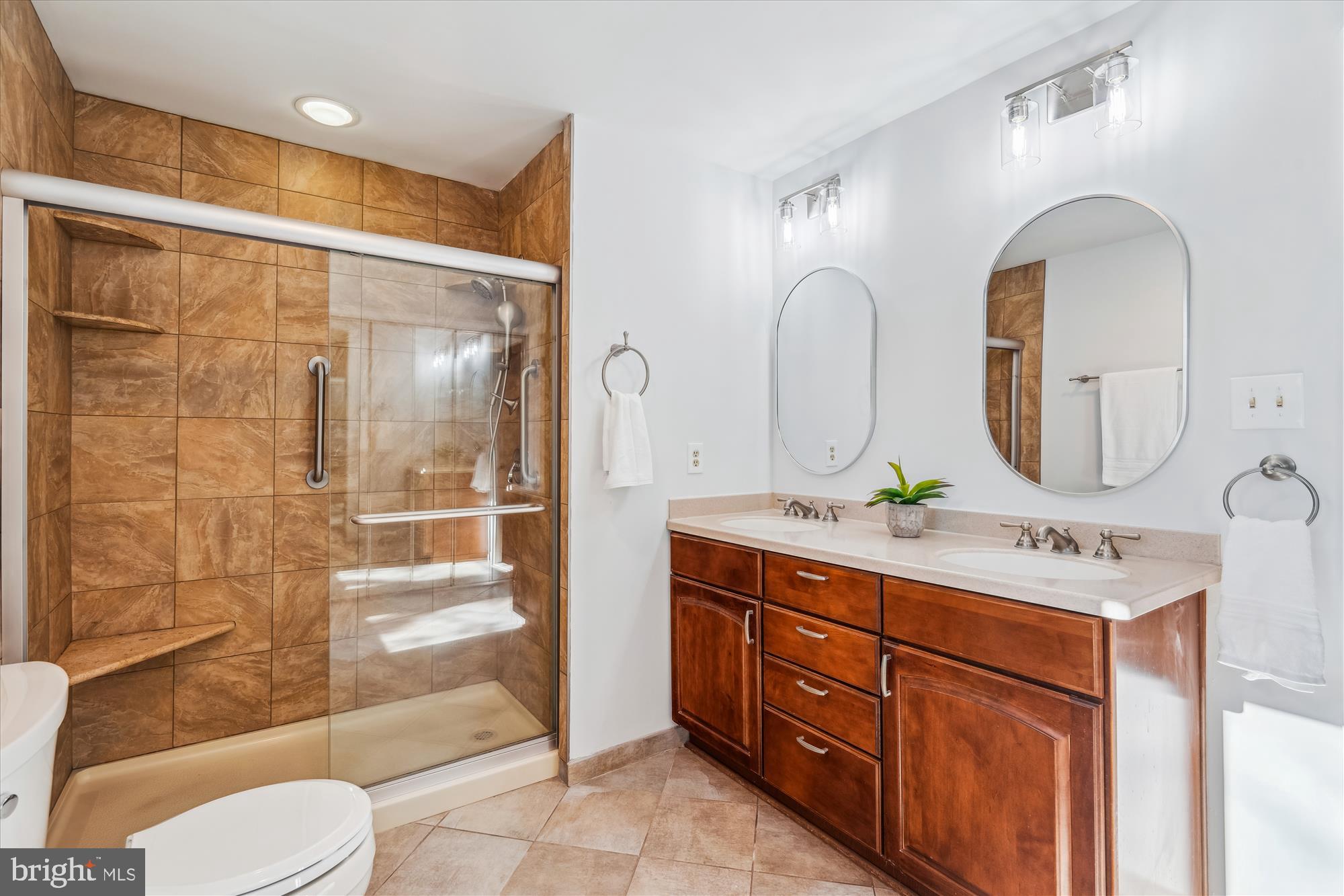 4048 Arjay Circle Ellicott City, MD 21042 - Photo 38 of 56 a bathroom with a double vanity sink toilet mirror and shower