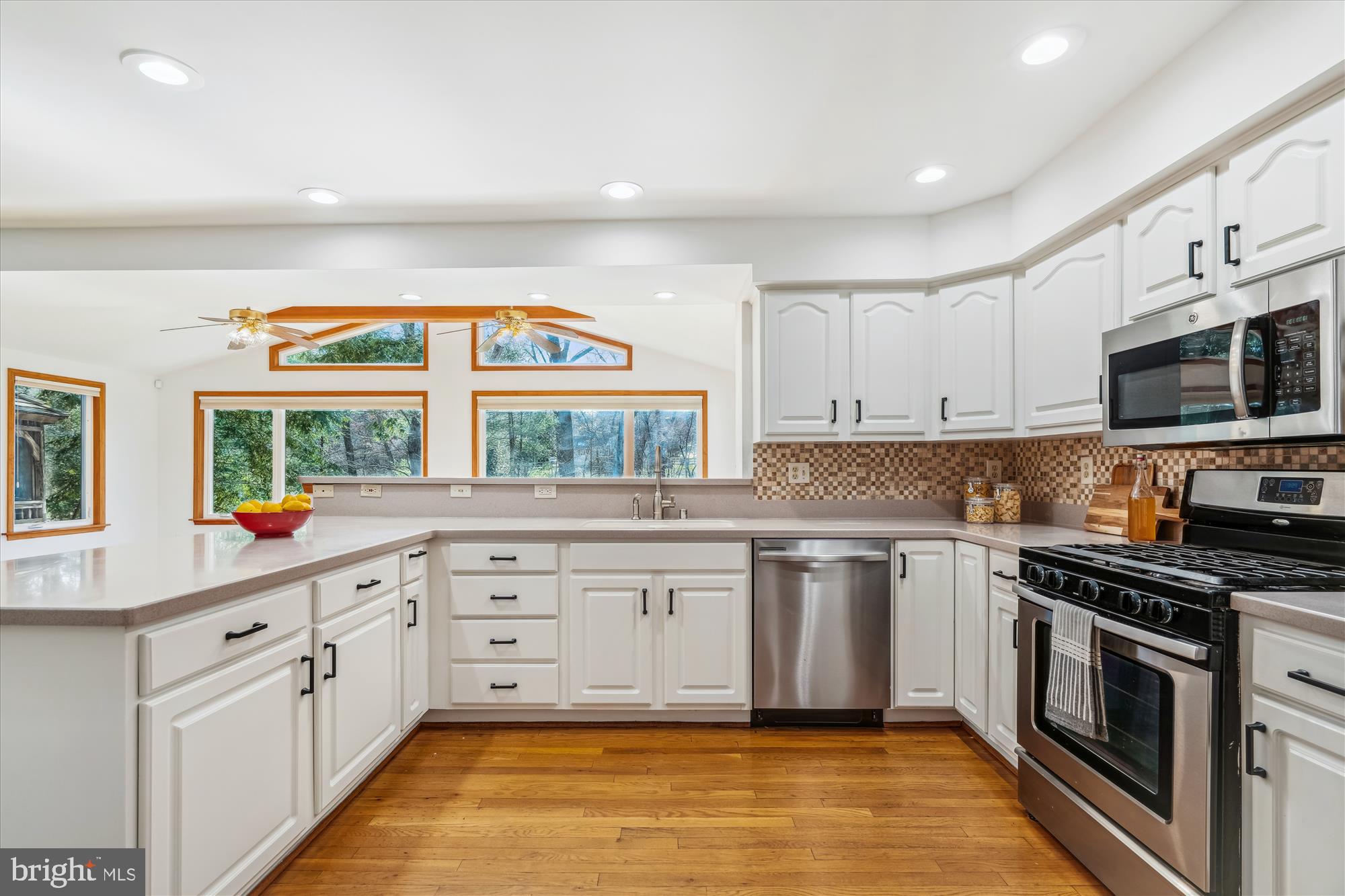 4048 Arjay Circle Ellicott City, MD 21042 - Photo 8 of 56 a kitchen with stainless steel appliances granite countertop a stove a sink and a microwave