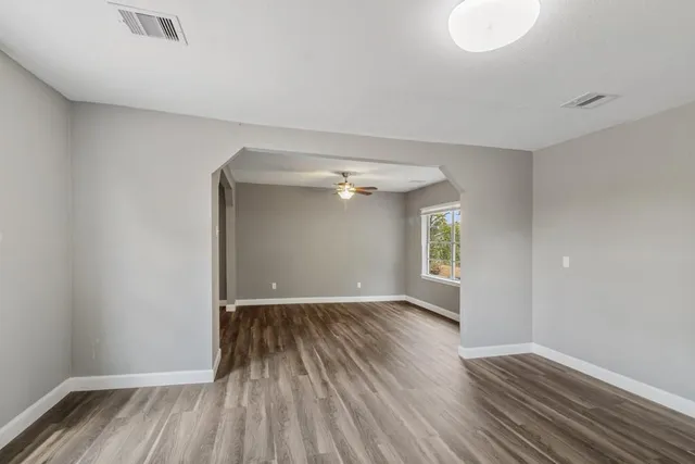 wooden floor in an empty room with a window