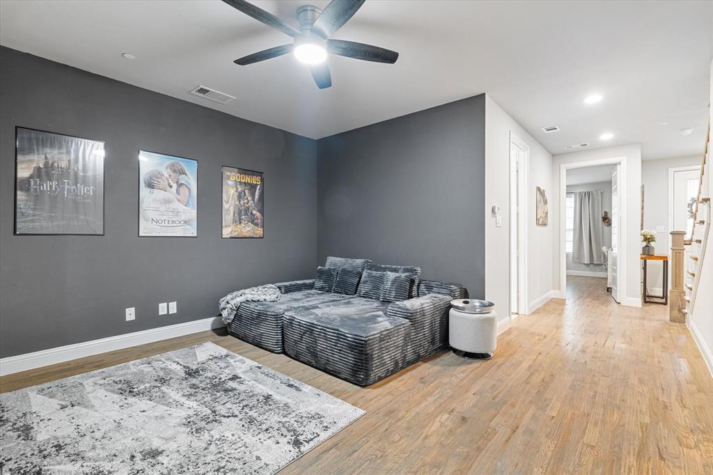 6013 Page Street Frisco, TX 75034 - Photo 12 of 38 a bedroom with a large bed and a chandelier