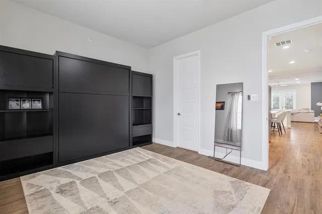 a bedroom with a bed and a television