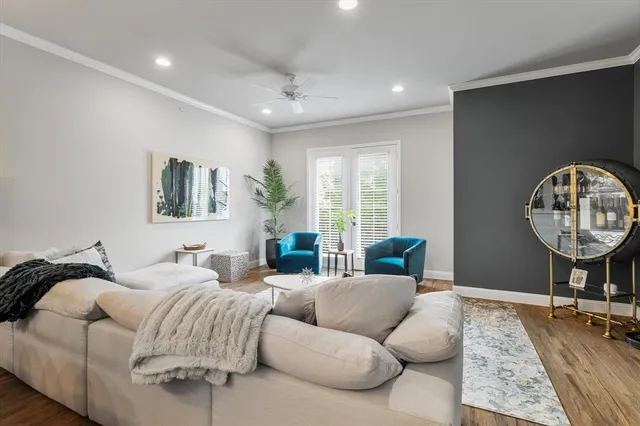 a living room with furniture a rug and a large window